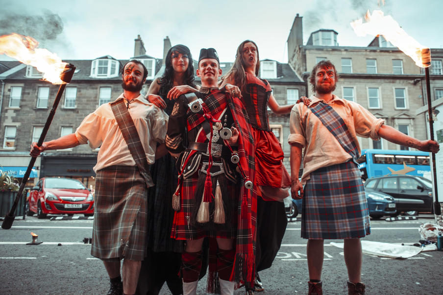 Roddy the Piper with fire performers and stilt walkers provide a Scottish welcome for gala dinner