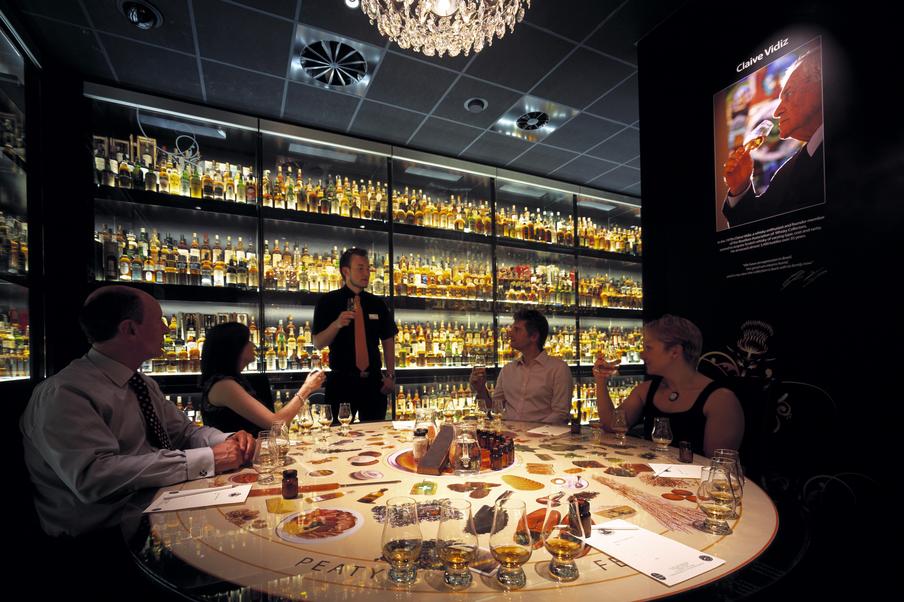 A group of people enjoying a private whisky tasting with a tutor within The World's Largest Collection of Scotch Whisky.