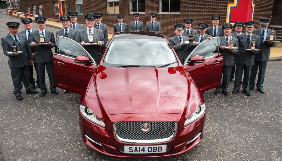 Little's team of fully uniformed chauffeurs gather around one of our Jaguar XJL's after a full day of training at the Tennents Brewery in Glasgow. 
