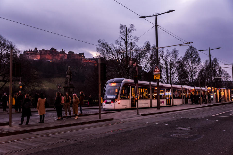 Photo of Tram at Night in Front of Castle
