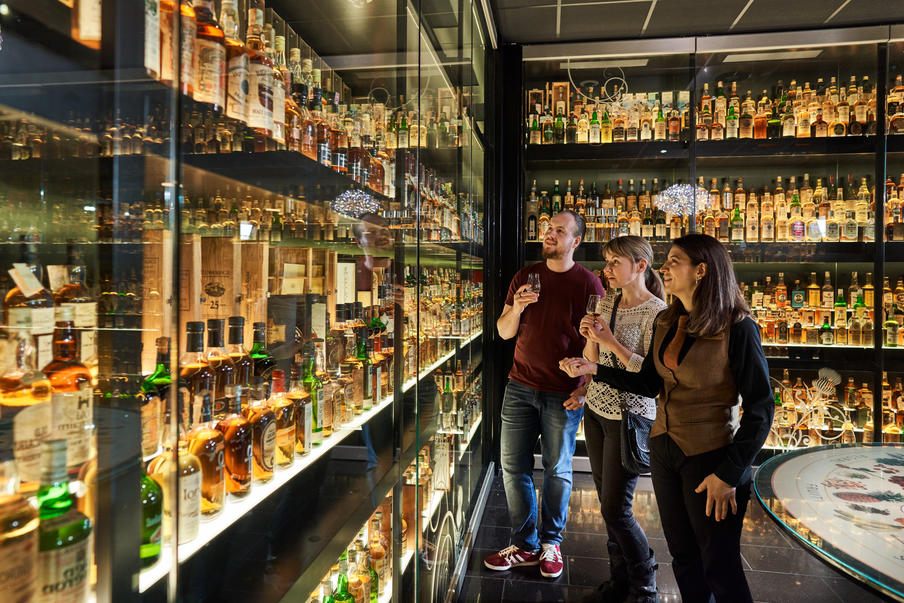 3 people in the glass vault of The Collection.