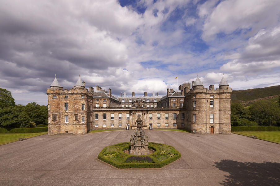 The full exterior of the Palace on a cloudy, but blue sky day.