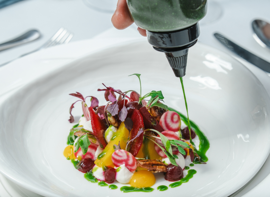 A colourful salad with three types of beetroot, whipped goats cheese colourful beetroot puree, microherbs and green oil