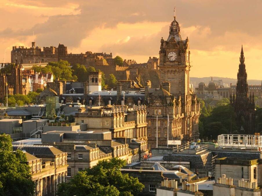 Edinburgh skyline at sunset featuring the Balmoral Tower.